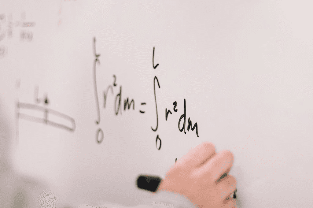 A teacher explaining course material on a whiteboard